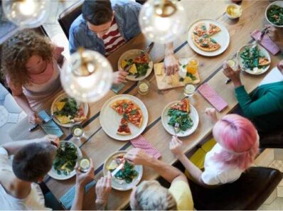 French people sitting around a table having lunch together during the French lunch break